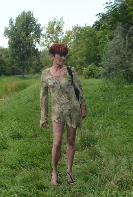 Redhead granny Angela Reed blows young man's manhood and gets fucked on the couch