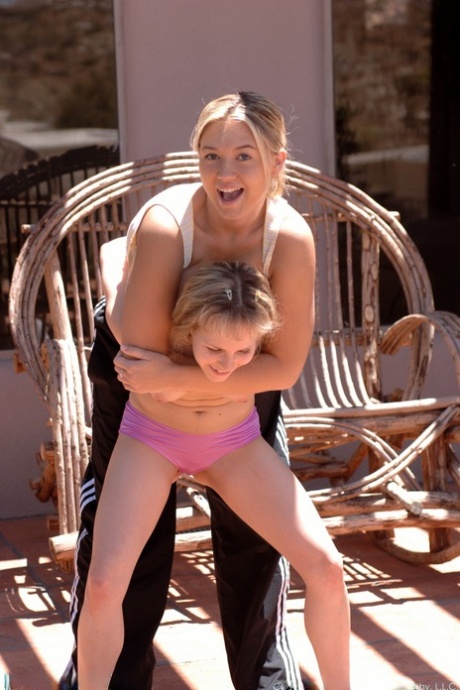 Cutie in pink panties Fiona Luv fights with busty Alison outdoors
