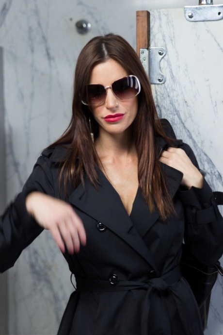 Smoking Gia DiMarco opens trench coat to sit on men's toilet in attractive lingerie