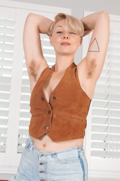 Short haired blonde Dakota Rose shows her attributes & flaunts her hairy cunt