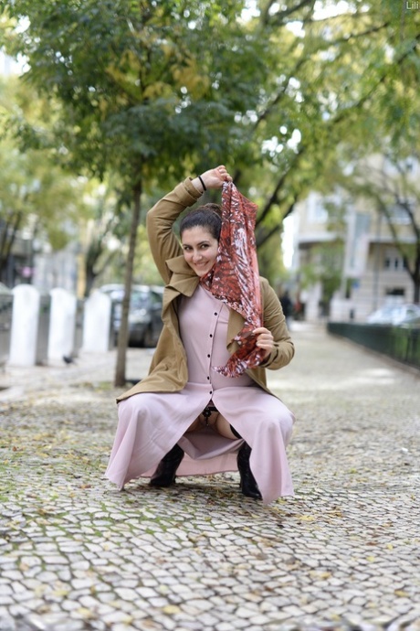 Cute authentic mom Lili flashes her muff as she poses pantyless in public