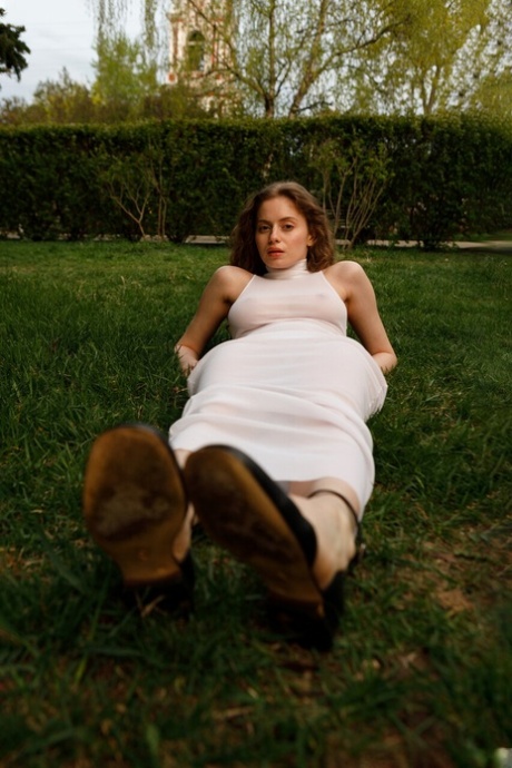 Beautiful braless authentic babe with big breasts posing in her white dress outside