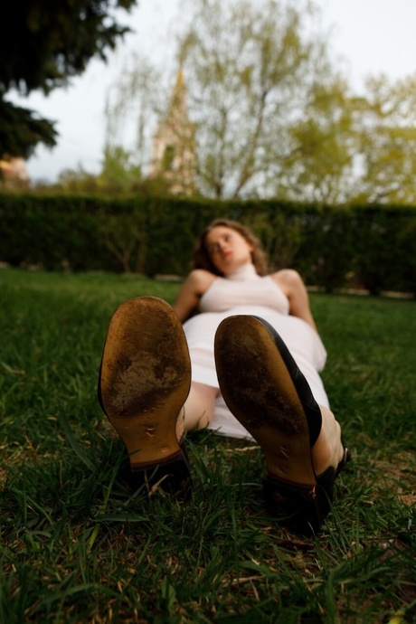 Beautiful braless authentic babe with big breasts posing in her white dress outside