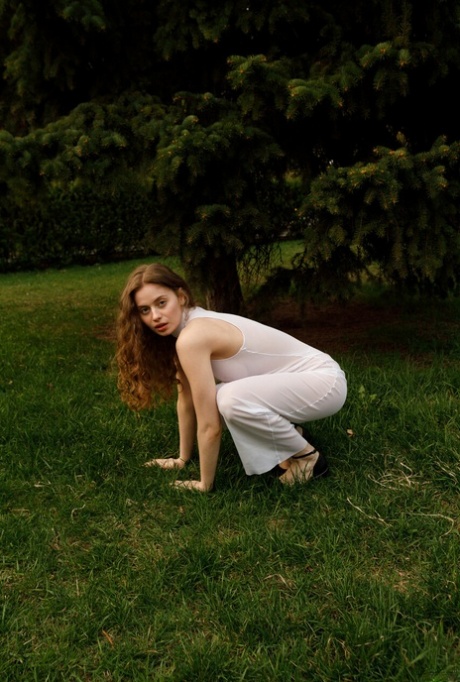 Beautiful braless authentic babe with big breasts posing in her white dress outside