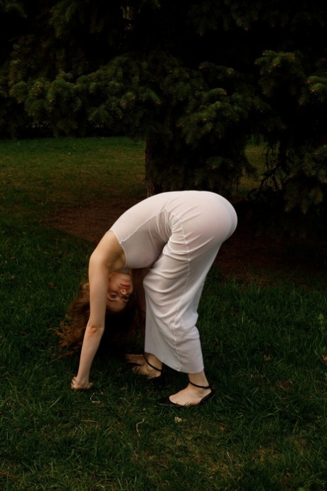 Beautiful braless authentic babe with big breasts posing in her white dress outside