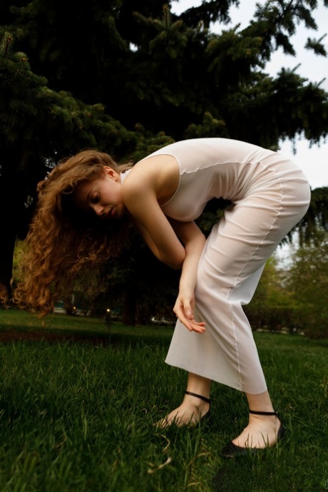 Beautiful braless authentic babe with big breasts posing in her white dress outside