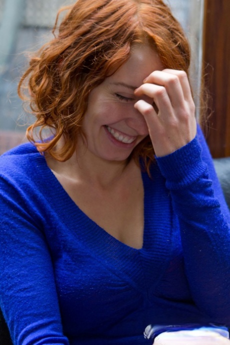 Natural redhead Kara Dashka does a slow striptease on an office chair