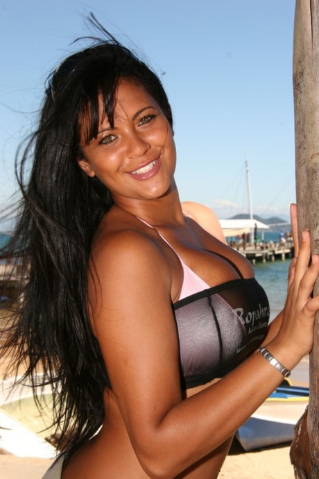 Beautiful busty Latina Babalu gets a massive open mouth facial at the beach