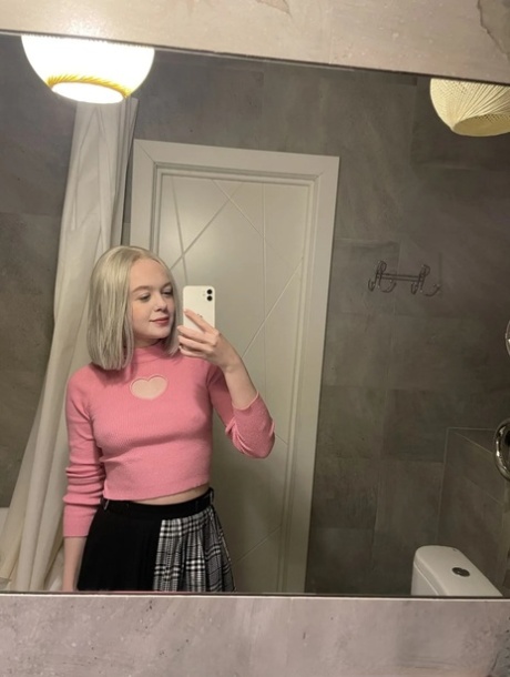 Blonde young adult takes nudes showing her small breasts & her butterfly tattoo