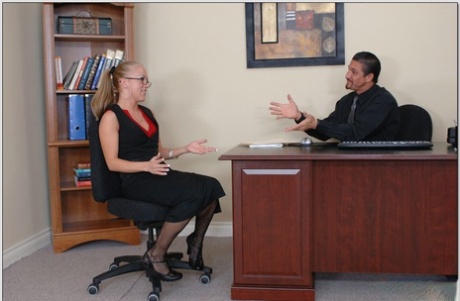 Blonde secretary Kylie Wilde shows her small breasts and gets fucked in fishnets