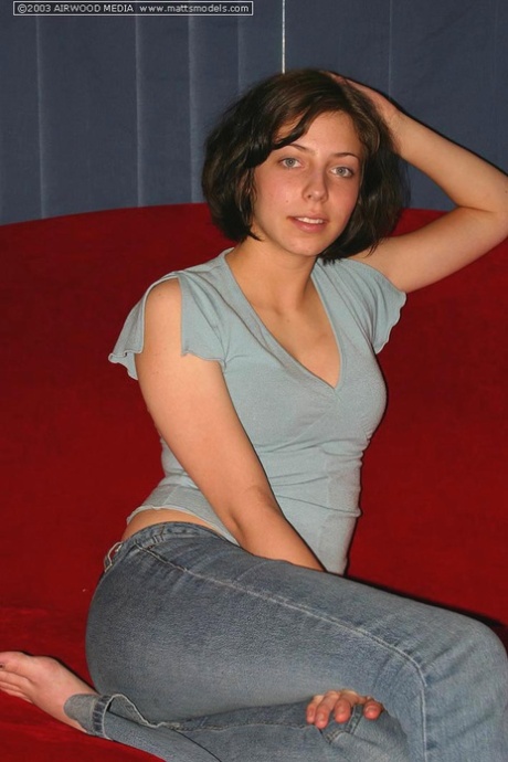 Young brunette model Nico uncovers her pert breasts before parting femininity lips