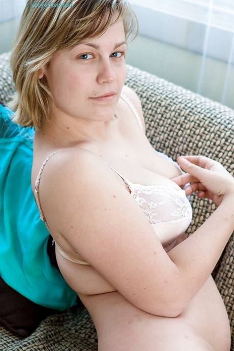 Busty blonde Augustine poses in lingerie before spreading hairy cooter