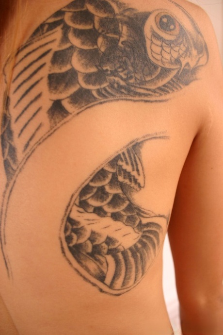 Skinny Asian young adult with slender body Apple stripping and revealing big tattoo