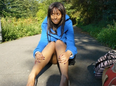 Ebony chick fingers her femininity on roadway while a jogger passes by