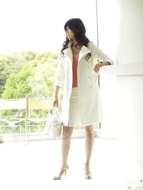 Clothed Japanese model Yuka Yamada shows her bare legs in a skirt