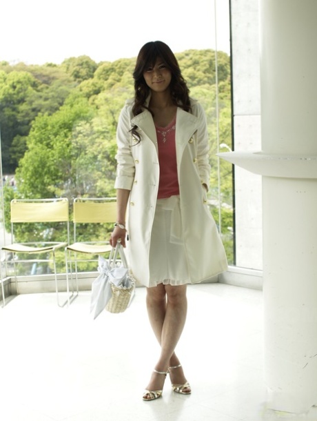Clothed Japanese model Yuka Yamada shows her bare legs in a skirt