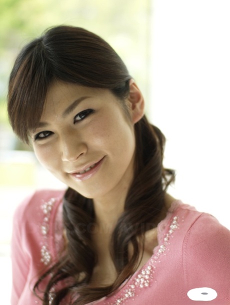 Clothed Japanese model Yuka Yamada shows her bare legs in a skirt