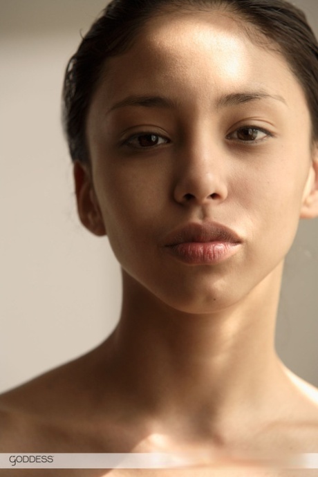 Thin young adult Alexis thrusts her perky breasts forth in front of a mirror