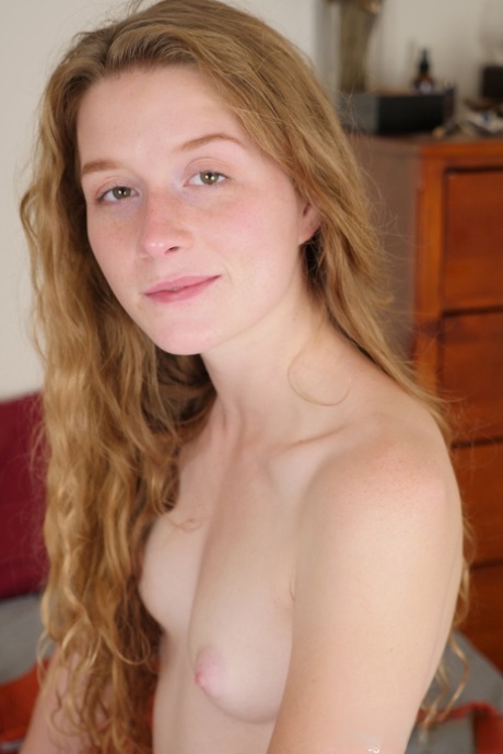 Pale redhead Karina Pontiac slips off her robe to model totally natural on bed