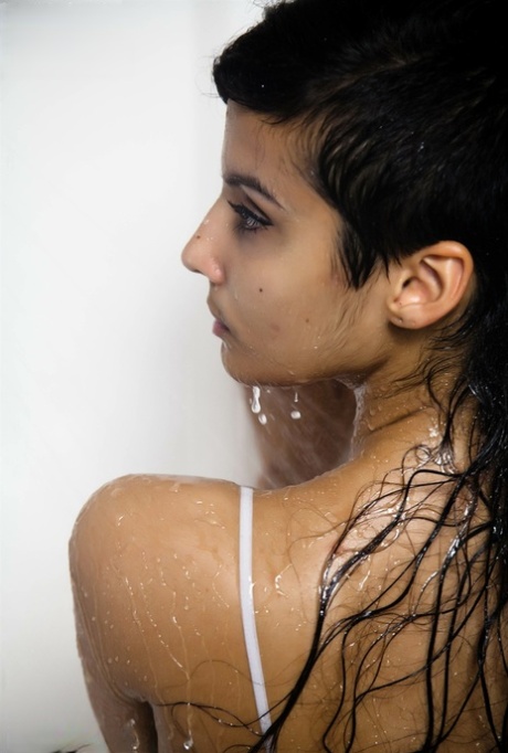 Indian solo girl takes off her wet dress to pose artistic in the bathtub