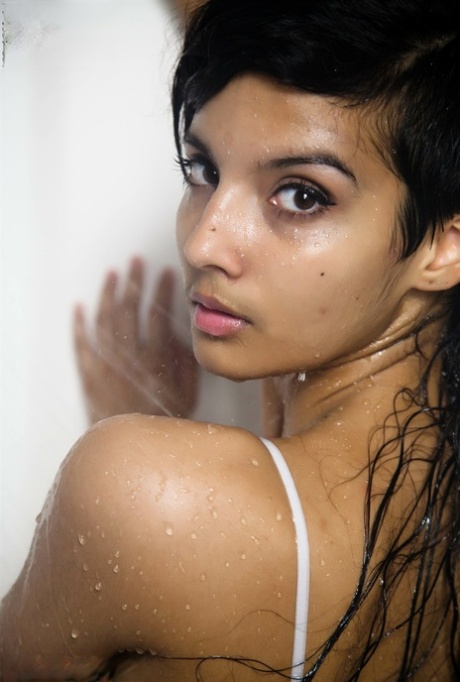 Indian solo girl takes off her wet dress to pose artistic in the bathtub