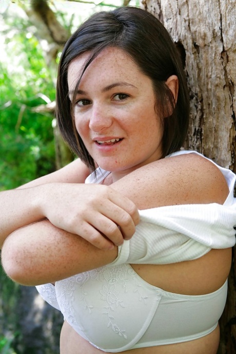 Chubby girl with freckles and big natural breasts spreads hairy cunt outside