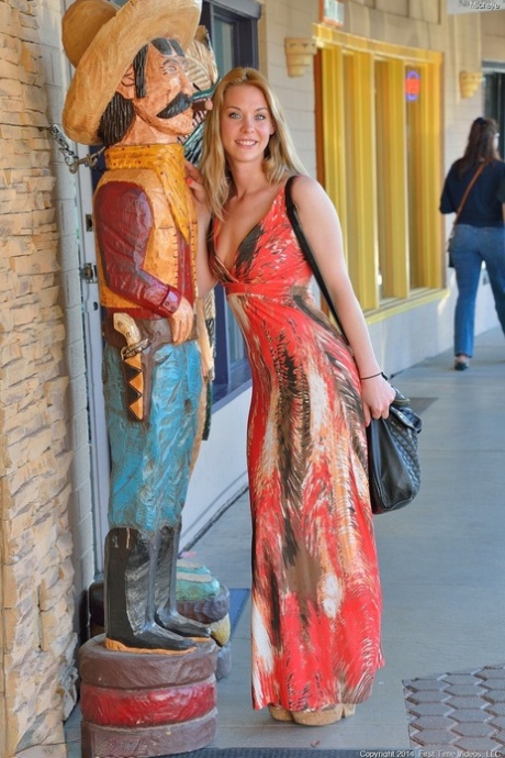 Glamour babe in a alluring dress Michelle flashing a pantyless upskirt in public