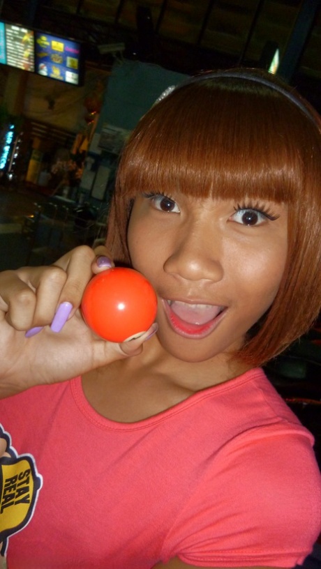 Red-haired Asian ladyboy lifts dress up to flash manhood in public place