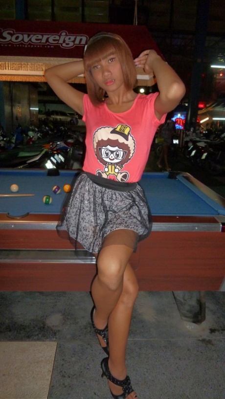 Red-haired Asian ladyboy lifts dress up to flash manhood in public place