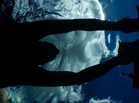 Authentic mom Nikki Sims playing with her covered up breasts in swimming pool