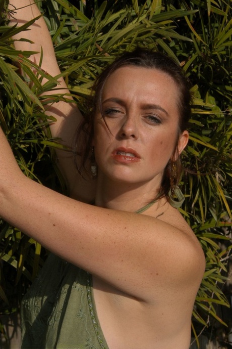 Alluring big boobed MATURE WOMAN Katiana gets artistic in the garden and massages her clit