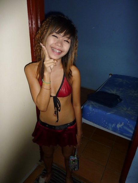 Tiny Thai bar girl Ploy displaying tight curves and femininity on bed