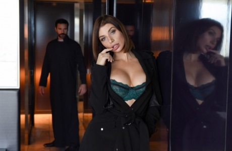 Brunette chick covers up her natural breasts in front of a Priest