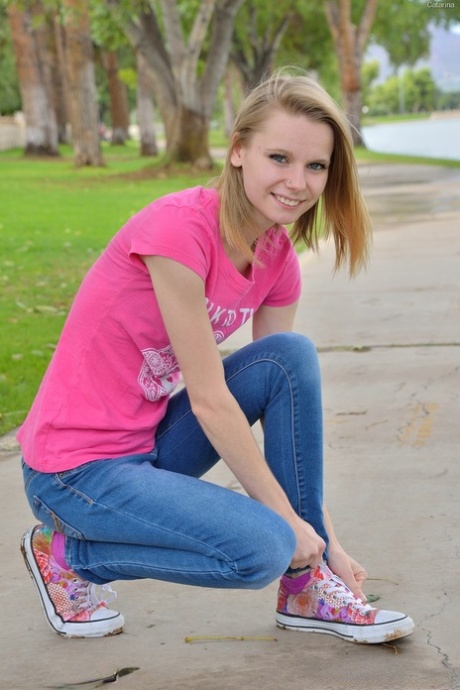 Sweet skinny young adult Catarina unveils her tiny breasts and tasty clam at the park