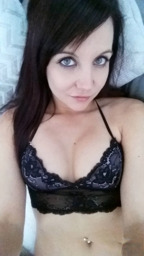 Slim young adult Andi Land takes candid artistic and clothed selfies while at home