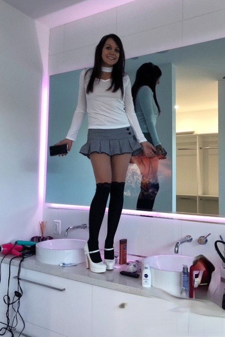 Slim young adult Andi Land takes candid artistic and clothed selfies while at home