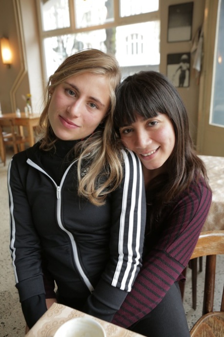 Two alluring authentic models pose artistic and touch their shaved pussies