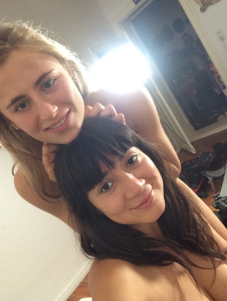 Two alluring authentic models pose artistic and touch their shaved pussies