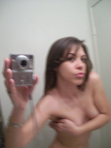 Authentic young adult shows off her fine curves in panties while taking artistic photos