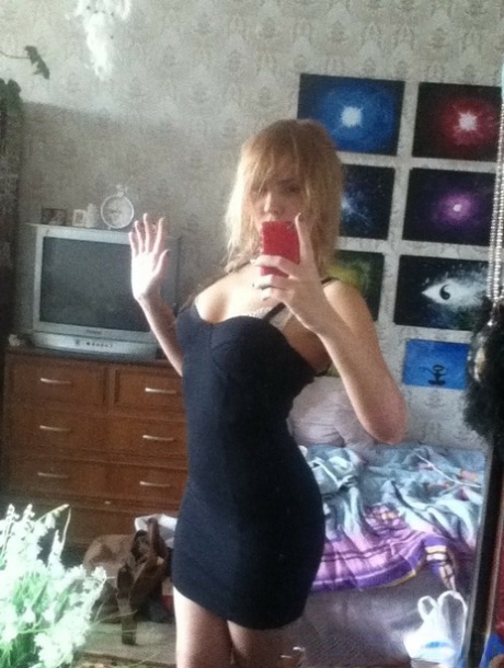 Blonde authentic takes alluring artistic selfies while trying on various outfits