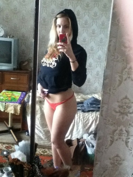 Blonde authentic takes alluring artistic selfies while trying on various outfits