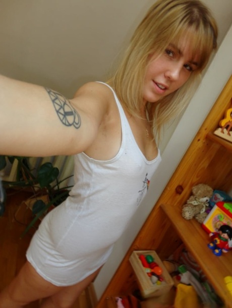 Blonde authentic takes alluring artistic selfies while trying on various outfits