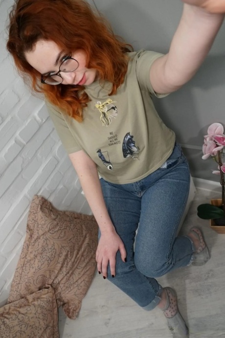 Lovely redhead takes artistic selfies showing her juicy breasts & her big curves