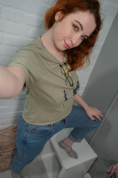 Lovely redhead takes artistic selfies showing her juicy breasts & her big curves