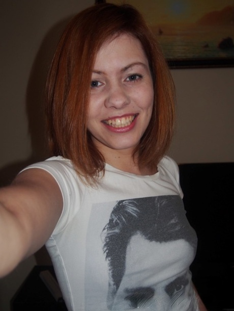 Redheaded young adult takes artistic selfies showing her natural tiny breasts