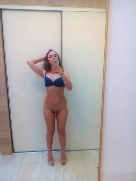 Authentic sweetheart takes selfies as she poses and strips in the mirror