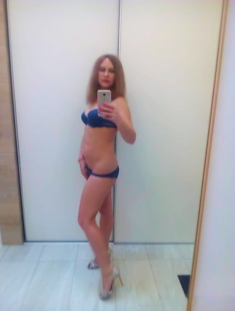 Authentic sweetheart takes selfies as she poses and strips in the mirror