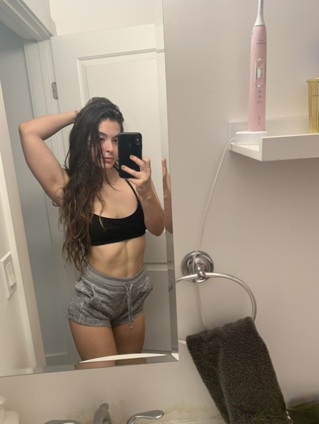 Authentic model holds her bare curves during a series of artistic selfies