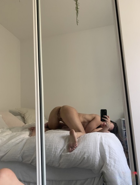 Authentic model holds her bare curves during a series of artistic selfies