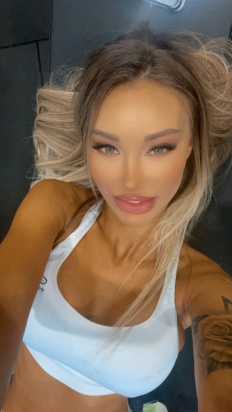 Petite babe Monika Fox shows off her big boobs with pierced nipples at the gym